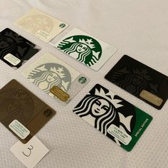 various starbucks credit cards laid out on a bed