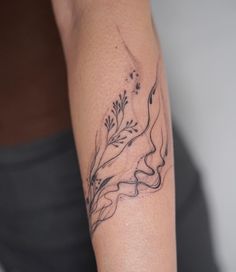 a woman's arm with a tattoo design on the left side of her body