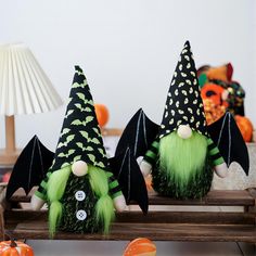 three green and black witches sitting on top of a table