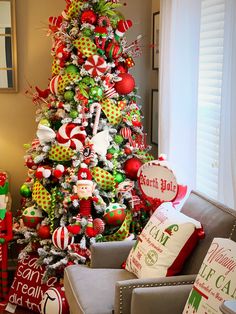 the christmas tree is decorated with red, green and white ornaments