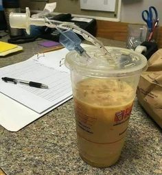 a plastic cup filled with liquid sitting on top of a counter