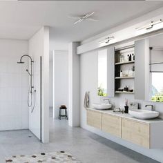 a bathroom with two sinks and a shower in the corner, along with a rug on the floor