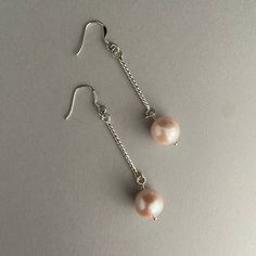 Would you like to have a pair of earrings as unique as you are.   Well these may be for you.  How gorgeous would these be with a wedding gown, or a party/holiday dress.   This is a gorgeous handmade sterling silver and genuine pearl pair of earrings.   The silver is a beautiful twisted wire.    The genuine pearl is a very nice quality, very large 12mm with pinky peachy tones.   They have a lot of luster and are very bright looking. All the rings and pearls swing separately which bring alot of mo Pearl Drop Dangle Earrings For Party, Dangle Pearl Earrings For Bridesmaid Gift, Pearl Dangle Earrings For Bridesmaid Gift, Evening Pearl Dangle Bridal Earrings, Hypoallergenic Pearl Earrings For Parties, Evening Dangle Pearl Earrings With Pearl Charm, Pearl Long Drop Earrings For Party, Long Drop Pearl Earrings For Party, Elegant Hypoallergenic Pearl Earrings For Party