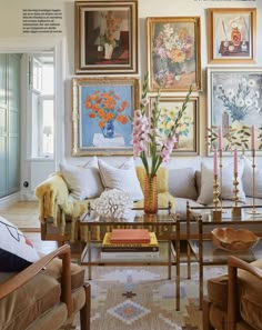 a living room filled with furniture and pictures on the wall above it's coffee table