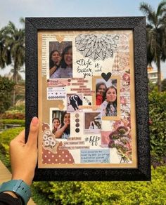 a person holding up a frame with pictures and words on it in front of some bushes