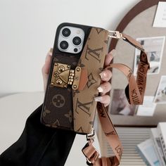 a woman is holding up her phone case with the louis vuitton logo on it