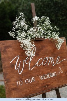 a welcome sign with baby's breath on it