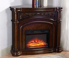 a fireplace with a fire in it and books on the top shelf next to it