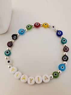 This is a beautiful Sterling Silver and multi color glass Evil Eye YiaYia bracelet. Made with the highest quality stretch magic cord. Choose your size. Comes in a chiffon bag ready to gift! We can also personalize with the name of your choice. Hand-strung Multicolor Beads For Gifts, Bohemian Czech Glass Stretch Bracelet Gift, Multicolor 8mm Beads Stretch Bracelet As Gift, Bohemian Silver Beaded Bracelets With Letter Beads, Adjustable Colorful Beads Stretch Bracelet As Gift, Spiritual Silver Stretch Bracelet With Letter Beads, Bohemian Rainbow Stretch Bracelet Gift, Adjustable Multicolor Czech Glass Stretch Bracelet, Multicolor Stretch Bracelet With Round Beads As Gift