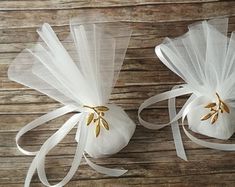 two white organ bags with gold trims on wooden table next to eachother