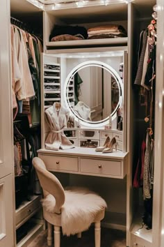 a white dressing table with a mirror and stool