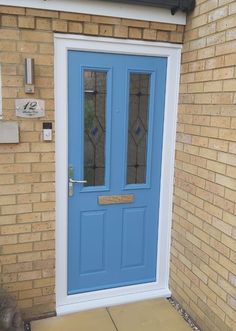 a blue front door on a brick building