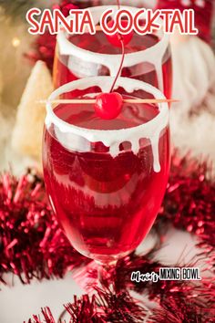 two glasses filled with red liquid and topped with a cherry on the top, surrounded by confetti