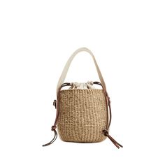 Chloe x Mifuko "Woody" bucket bag in straw, cotton, and leather  Branded flat web top handle  Flat shoulder strap Drawstring closure  Leather lining  Approx. 6.3"H x 6.7"W x 6.3"D Made in Italy Beige Crochet Bucket Bag With Leather Handles, Natural Color Bucket Straw Bag, Handwoven Straw Bucket Shoulder Bag, Top Handle Jute Bucket Bag, Jute Straw Bucket Bag With Bamboo Handle, Jute Straw Bag With Bamboo Handle In Bucket Shape, Jute Straw Bag With Bamboo Handle And Bucket Shape, Natural Jute Top Handle Bucket Bag, Beige Woven Bucket Bag