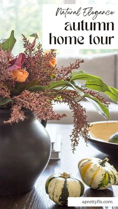 an autumn home tour with pumpkins, flowers and greenery in a vase on a table