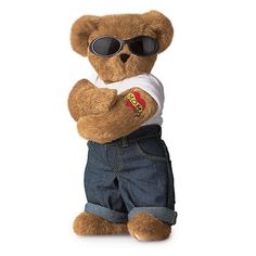 a brown teddy bear wearing sunglasses and denim shorts, with his arms crossed in the air