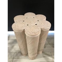 four white vases are stacked on top of each other