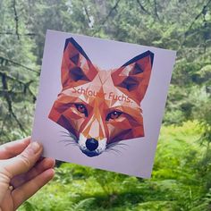 someone holding up a card with an image of a fox