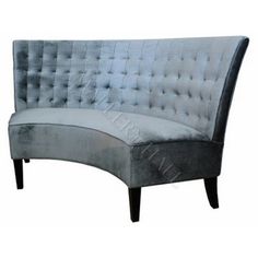 a gray velvet couch with black legs and buttons on the back, sitting against a white background