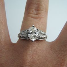 "For sale: (1) d863 Stunning 14k White Gold Engagement Ring PLEASE READ ENTIRE DESCRIPTION BEFORE PURCHASING Pre-owned item. Good condition. Please see pictures for details. Sold as is, as seen on pictures. This ring contains 35 diamonds. The centerpiece is oval cut; two diamonds are baguette cut; 32 are round cut. This ring is stamped on the inside of the shank. Has GIA Certificate on center oval diamond. See picture for details. Specifics: 14k White gold Diamonds: 1.40TCW Size: 6.75 (U.S.) Wid Elegant Gia Certified Marquise Wedding Ring, Classic Marquise Sterling Silver Wedding Ring, Classic Marquise Diamond Ring With Vs Clarity, Classic Marquise Rings With Vs Clarity, Gia Certified Timeless Marquise Cut Wedding Ring, Heirloom Oval Diamond Ring With Vs Clarity, Timeless 14k White Gold Marquise Cut Jewelry, Gia Certified Marquise Jewelry For Wedding, Gia Certified Elegant Marquise Cut Ring