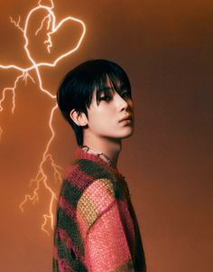 a young man standing in front of a lightening background with his head turned to the side