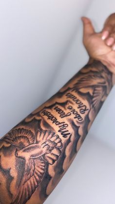 a man's arm with an eagle tattoo on it and words written in black ink