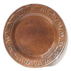 a brown plate with an ornate design on it