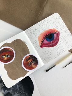 an open book with stickers on the pages and pictures of eyeballs in it