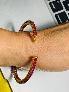 This bingle will elevate your whole outfit for any special occasions.  Natural Unheated Burmese Ruby Bangle in 18K Yellow Gold.  Weight of Ruby 35 pcs  5.2 ct Length and width of each Ruby  3.72x2.94 mm , 3.10x2.45 mm (Average) Length and Width of Bangle  Size 54.98 x54.27 mm Length and width of Ruby  63.71 mmx 3.90 mm Total weight of Bangle  11 gm Gemstone  -  Unheated Burmese Ruby Treatments - None Colour  -  Intense Red Transparency  -  Transparent / Highly Transparent Clarity -   VVS  14 pcs Gemstone Tennis Bracelet For Wedding, Wedding Gemstone Tennis Bracelet, Formal Yellow Gold Ruby Bangle, Diamond Bangle Bracelet With Gemstones, Wedding Bangle With Gemstone, Gold Ruby Bangle, Gold Ruby Tennis Bracelet For Anniversary, Gold Ruby Diamond Bracelet For Wedding, Round Ruby Tennis Bracelet For Wedding