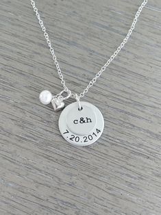 "« Couples Necklace hand stamped with initials and date - personalized disc necklace - personalized pendant with pearl and heart charm » THE DETAILS: » 1/2\" aluminum disc hand stamped with two initials in typewriter font » 3/4\" aluminum disc stamped with a date » freshwater pearl and sterling silver heart charm » 18\" oval link chain Aluminum is a light weight, tarnish resistant metal. Please leave your initials and date info in the \"note to seller\" box during check out. » Each necklace is c Couple Necklaces, Personalized Pendant, Disc Necklace, Sterling Silver Heart, Name Necklace, Heart Charm, Jewelry Care, Personalized Jewelry, Hand Stamped