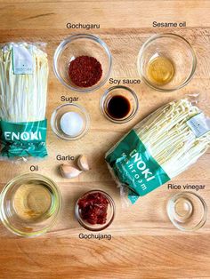 ingredients to make an italian pasta dish laid out on a wooden table with labels labeled