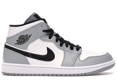 the air jordan 1 mid is shown in grey and white with black detailing on the upper part