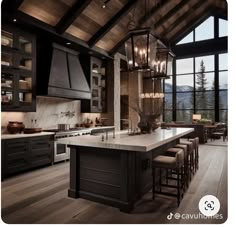 a large kitchen with an island and lots of counter space in front of the windows