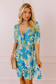 You will be the buzz of the town when you arrive in this pretty blue dress featuring lightweight breezy material patterned with a teal, green, and white floral print, a v-cut neckline with a front tie detail, loose half sleeves, and a relaxed skirt silhouette that falls into a straight mid-thigh length hemline! on products Measurements S : Bust 34", Hip 38", Length 36", Sleeve Length 12.5", Waist 28-30". M : Bust 36", Hip 40", Length 36", Sleeve Length 13", Waist 30-32". L : Bust 38", Hip 42", L Blue Floral V-neck Dress For Vacation, Blue Summer Mini Dress For Garden Party, Summer Mini Dress For Garden Party In Blue, Blue Floral Print Mini Dress For Day Out, Blue Printed Floral Dress For A Day Out, Blue V-neck Mini Dress With Tie Back, Blue Summer Floral Dress For Brunch, Blue Floral Summer Dress For Brunch, Blue V-neck Mini Dress With Tie Waist