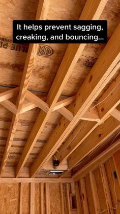 the inside of a house with wood framing and exposed ceiling beams that are being worked on