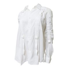 A fabulous fine white cotton shirt from Junya Watanabe for Comme des Garcons (CDG). It has a shirt collar, long cuff sleeves and mother of pearl buttons up the front. The back fuller than the front has an opening under the yoke with a full gathered back below it. But what sets it apart are the adjustable drawstring cotton bands with buckles along the each side of the front plus the top and under side of each sleeve. Fits sizes Medium, Large. Marked Japanese size M. Bust 44" Sleeves 25" Length 28" Long Cuff Sleeves, Cdg Shirt, White Cotton Shirt, Junya Watanabe, Mother Of Pearl Buttons, Pearl Buttons, Comme Des Garcons, Shirt Collar, Cuff Sleeves