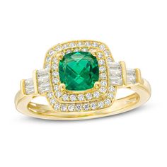 Top off your favorite looks with this glamorous fashion ring. Crafted in sterling silver with 14K gold plate, this Art Deco-inspired choice features a 6.0mm cushion-cut lab-created verdant-green emerald wrapped in a double frame of shimmering lab-created white sapphires. A stepped arrangement of baguette-cut created sapphires flanks the center stone. Buffed to a brilliant luster, this design expresses your sophisticated style. Custom-made to fit her ring size. Sterling silver rings cannot be res Luxury Gold Halo Ring With Accent Stones, Classic Gold Emerald Ring With Halo Setting, Classic Gold Emerald Cluster Ring, Gold Art Deco Ring With Halo Setting, Art Deco Gold Rings With Halo Setting, Gold Art Deco Rings With Halo Setting, Gold Emerald Ring With Baguette Cut Diamond Accents, Gold Halo Ring With May Birthstone Center Stone, Classic Gold Halo Ring With Gemstone