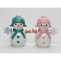 two ceramic snowmen with hats and scarves on their heads, one wearing a scarf