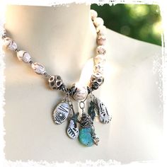 "Beautiful short talisman assemblage necklace with inlaid conch shell, lots of beachy charms, and a sterling wrapped turquoise pendant! Such a gorgeous OOAK ocean inspired choker ~ So much to look at but the whole effect is calming ~ like a walk on the beach at dawn. This piece is made up of some of my polymer clay seashell shards, Tibetan conch shell inlaid with turquoise, a beautiful turquoise hammered agate pear drop wrapped in sterling, big Hill Tribes sterling beads, artisan sterling heart White Bohemian Charm Necklace, Bohemian White Charm Necklaces, White Bohemian Jewelry With Dangling Charms, Turquoise Bohemian Charm Necklaces, Bohemian Turquoise Pendant Charm Necklaces, White Bohemian Necklace With Charms, Bohemian Turquoise Shell Necklace With Natural Stones, Turquoise Bohemian Shell Necklace With Natural Stones, Bohemian White Charms Necklace