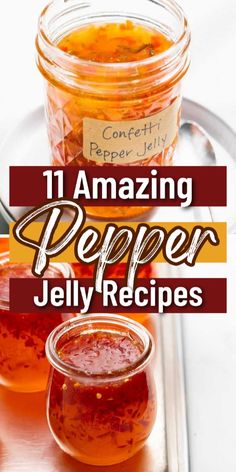 some jars filled with jelly sitting on top of a metal tray next to spoons