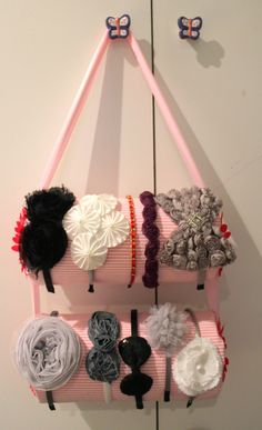 several different types of hair clips hanging on a wall