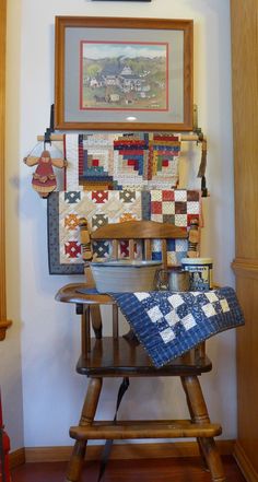 an old fashioned rocking chair with a quilt on it