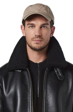 A sleek jacket from Corvus features a classic aviator silhouette. The jacket is crafted from smooth full grain lambskin leather with richly textured contrasting faux shearling lining the interior and the collar. The Black Leather Pilot Jacket with Shearling Collar is the perfect combination of style and function. Made from high-quality leather, this shearling moto jacket is designed to keep you warm and comfortable in any weather.Whether you're exploring the great outdoors or just running errand Classic Black Outerwear With Ribbed Collar, Luxury Black Outerwear With Ribbed Collar, Black Luxury Outerwear With Ribbed Collar, Fall Aviator Leather Jacket With Padded Collar, Aviator Leather Jacket With Padded Collar For Fall, Luxury Collared Leather Jacket For Winter, Black Winter Outerwear With Storm Flap, Black Leather Jacket With Ribbed Collar, Black Sheepskin Outerwear With Padded Collar