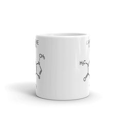 a white coffee mug with the chemical formulas drawn on it's front and side