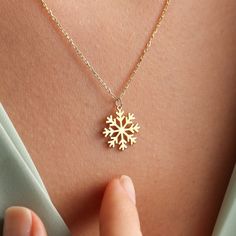 ✥ The perfect Christmas present, this 14k solid gold snowflake pendant combines classic style with joyous festive charm. The pendant, which is crafted in dazzling 14k pure gold, features a detailed snowflake design that exquisitely embodies the allure of winter. It elevates any ensemble with its sophisticated yet delicate design, making it the ideal accessory for the holidays. This snowflake pendant is a gorgeous option that will brighten her Christmas, whether you're looking for a special present for her or a sentimental piece of jewelry to commemorate the season. ✦ Metal Details✧ Metal Type: Solid Gold✧ Metal Purity: Available Options:14K | 18K✧ Metal Tone: Yellow Gold | White Gold | Rose Gold✧ Metal Certification: IDI Metal Authenticity Certificate✦ Chain Details:✧Chain Length: 14 Inche Snowflake Necklace For Christmas Anniversary, Christmas Snowflake Necklace For Anniversary, Elegant Festive Jewelry For Winter, Elegant Winter Jewelry As Gift, Elegant Winter Holiday Jewelry, White Gold Snowflake Jewelry For Christmas, Christmas White Gold Snowflake Jewelry, Christmas Snowflake White Gold Jewelry, Fine Jewelry Snowflake Gift