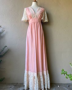 "Beautiful muted pink fairytale dress with lace detailing. So stunning!  --- Condition: Great vintage condition  --- Size: S  Shown on a size small mannequin with 26\" waist and 34\" bust Measurements:  --- @bluehoneyshop" Fitted Fairycore Dress With Lace Trim, Pink Fitted Cottagecore Dress, Feminine Lace Vintage Dress, Pink Lace Maxi Dress With Patchwork, Pink Lace Floor-length Dress, Pink Floor-length Lace Dress, Pink V-neck Lace Dress With Lace Trim, Pink Lace Maxi Dress With Lace Trim, Feminine Pink Dress With Delicate Lace