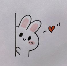 a drawing of a rabbit peeking out from behind a wall with a heart on it