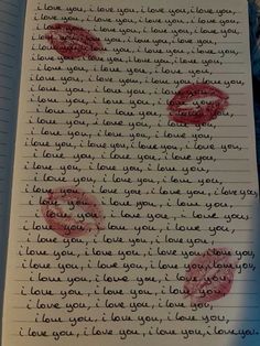 an open notebook with writing on it and two red lips drawn in the paper,