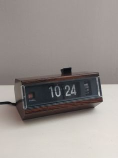 an alarm clock sitting on top of a table