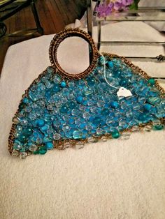 NWT Gorgeous Turquoise Beaded "Donnaterra"  Exquisite Bag ~HANDMADE by Artisans in BRAZIL~ This fun and colorful purse is by Donnaterra. The purse is a turquoise fabric, with gold wire looped all over it and adorned with clear & vibrant turquoise beads. It has 2 handles and closes with a magnetic snap. It measures 12" in length at the bottom and 6" in height. It is NWT *****From my Smoke & Pet Free Home **** Please see my other listings....I'm happy to combine shipping! Resin Purse, Multicolor Evening Bag With Colorful Beads, Bohemian Rectangular Bag With Colorful Beads, Unique Beaded Everyday Bags, Luxury Handmade Turquoise Bag, Elegant Multicolor Beaded Bag, Turquoise Purse, Fancy Purses, Hand Beaded Bag